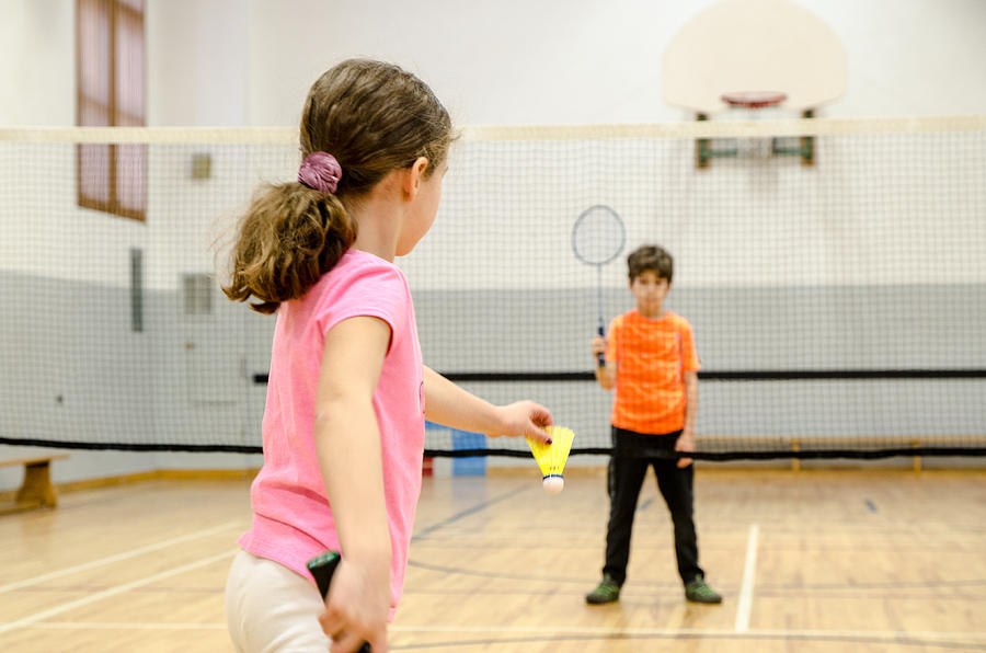 Two kids playing badminton in a gymnasium Photograph by Marc Dufresne