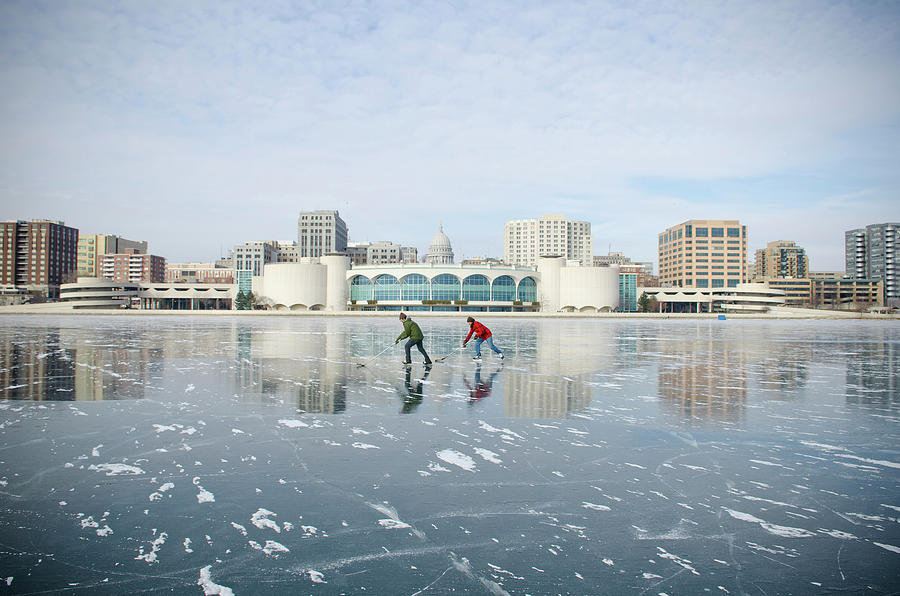 Two Male Adults Play Ice Hockey On Lake Photograph by David Nevala Two Male Adults Play Ice Hockey On Lake Photograph by David Nevala