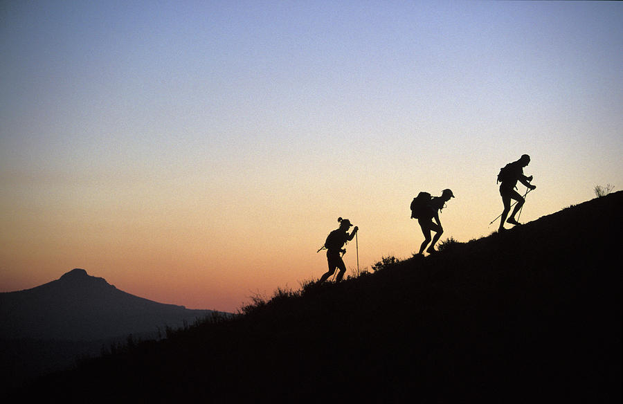 Back Light Photograph - Two Men And One Woman Run Up A Mountain by Corey Rich