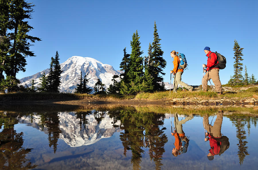 Two men hiking with Mt. Rainier in the background Photograph by Thinair28