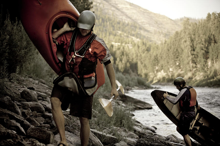Two Men Lift And Carry Their Boats Photograph by Kirk Mastin - Fine Art