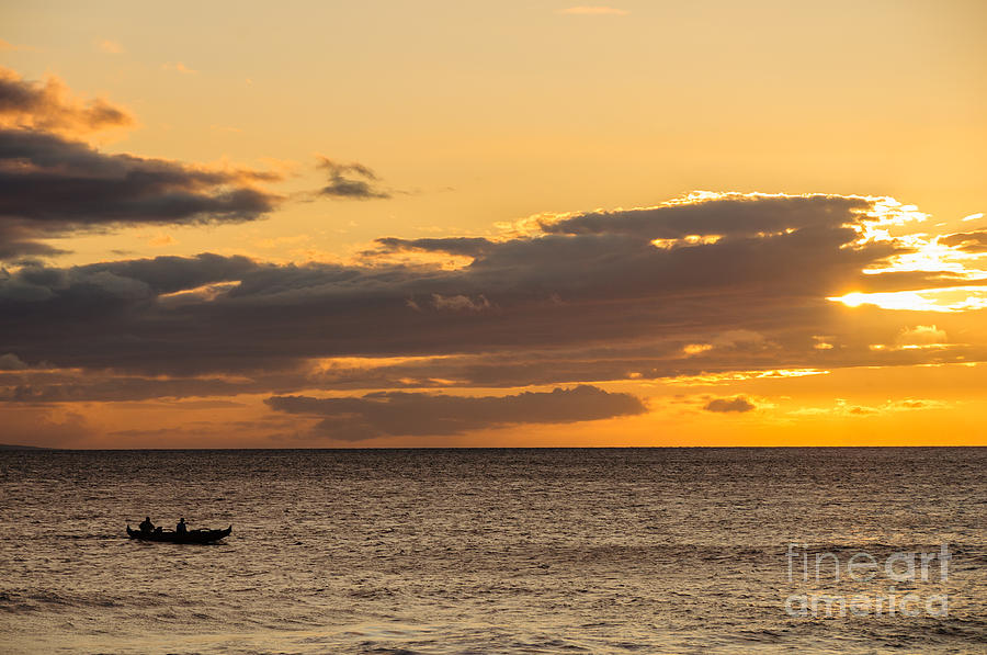 Two men paddling a Hawaiian outrigger canoe at sunset Maui Hawaii USA Photograph by Don Landwehrle