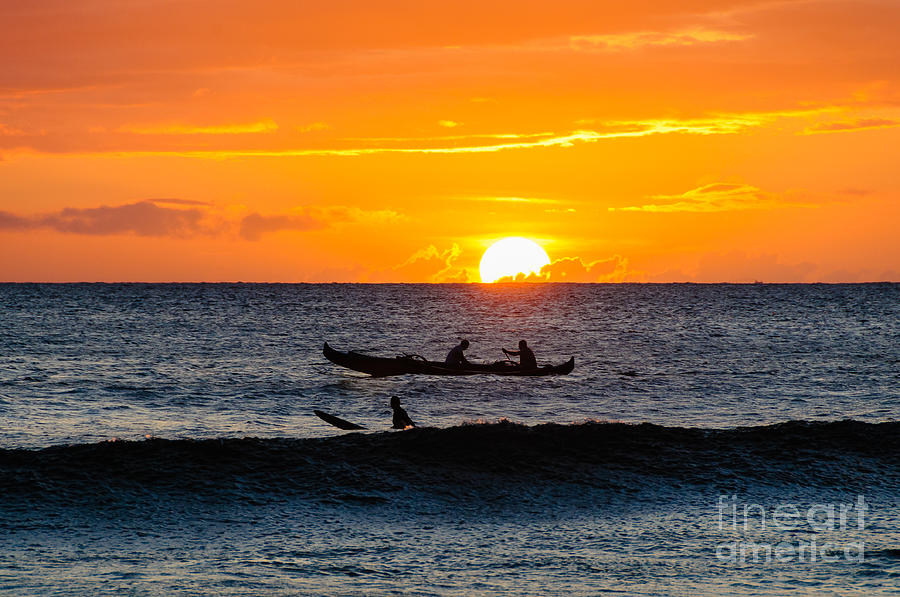 Two men paddling a Hawaiian outrigger canoe at sunset on Maui Photograph by Don Landwehrle