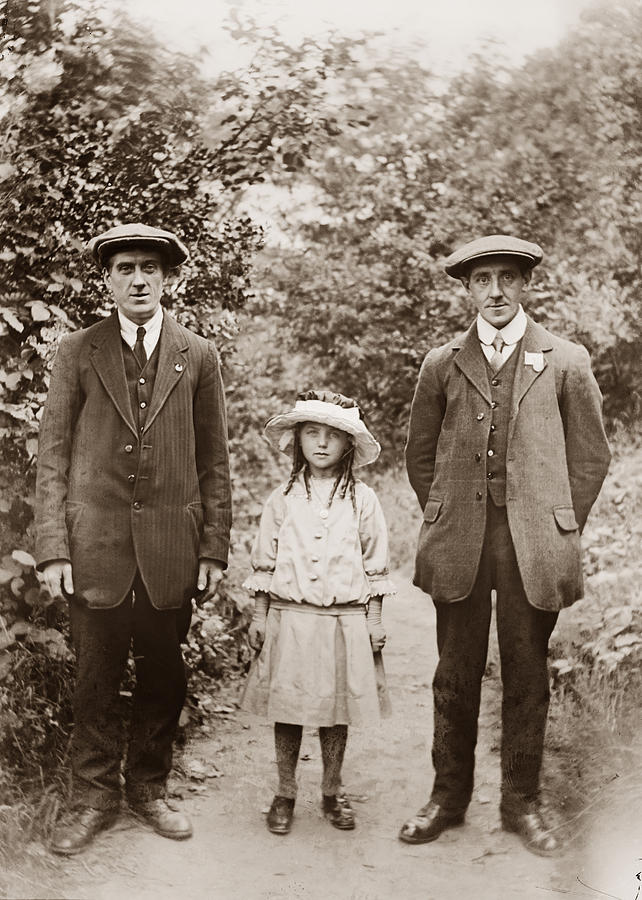 Two men standing with small girl Photograph by Photographer unknown