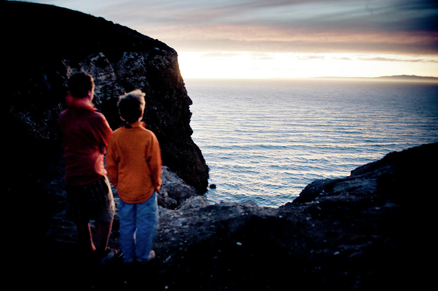 Sunset Photograph - Two Men Watch The Sunset Over The Ocean by Kevin Steele