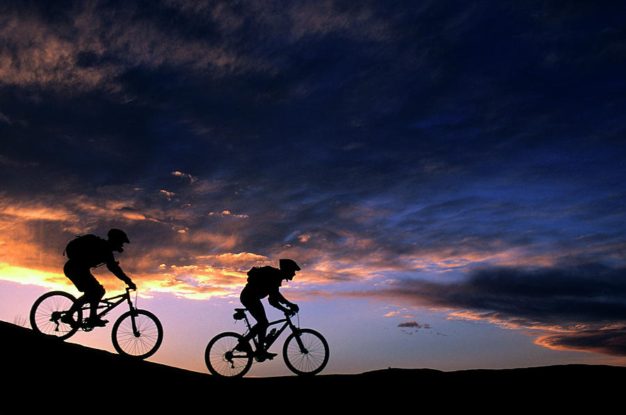 Sunset Photograph - Two Mountain Bikers On The Slick Rock by Richard Durnan