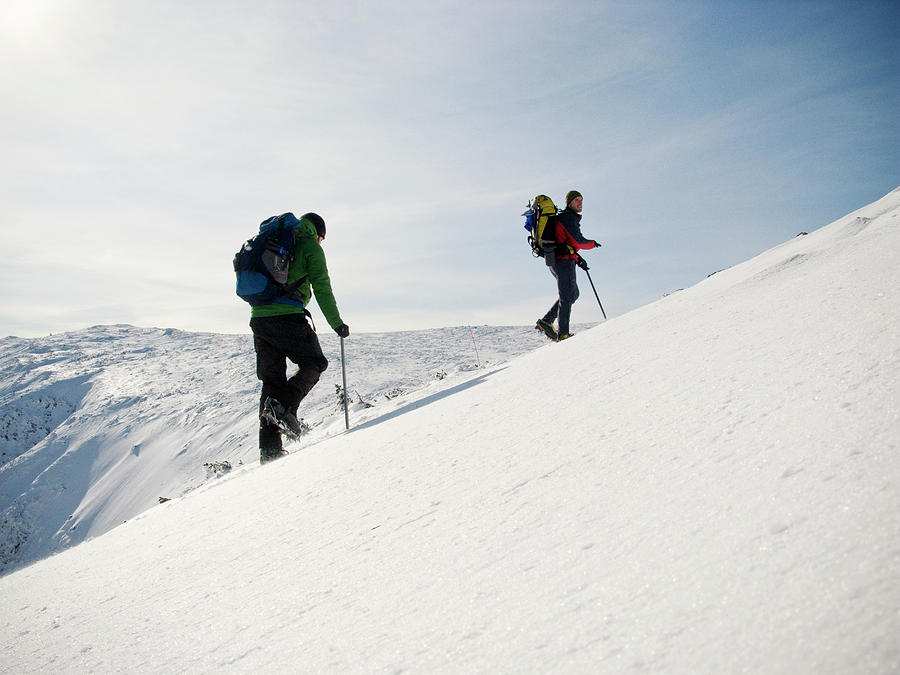 Two Mountain Climbers Ascend The Summit by Chris Bennett