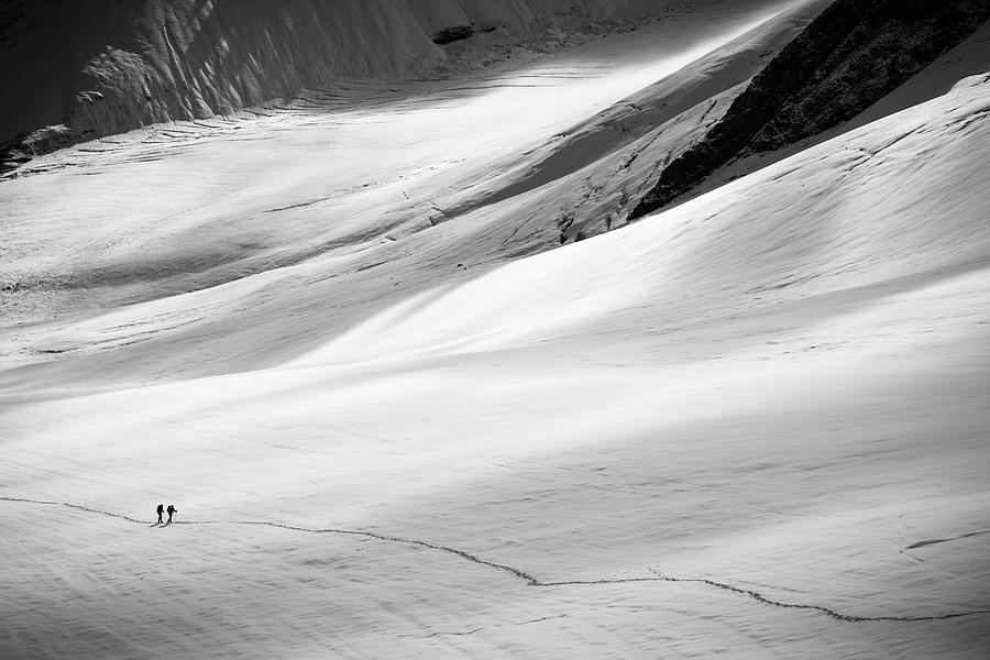 Nature Photograph - Two People Are Hiking On Snow In Spiti by Andrew Peacock