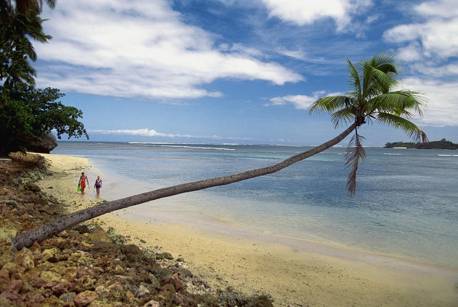 Two people walking on Warwick Resort Beach, Nadi, Viti Levu Island, Fiji Photograph by Medioimages/Photodisc