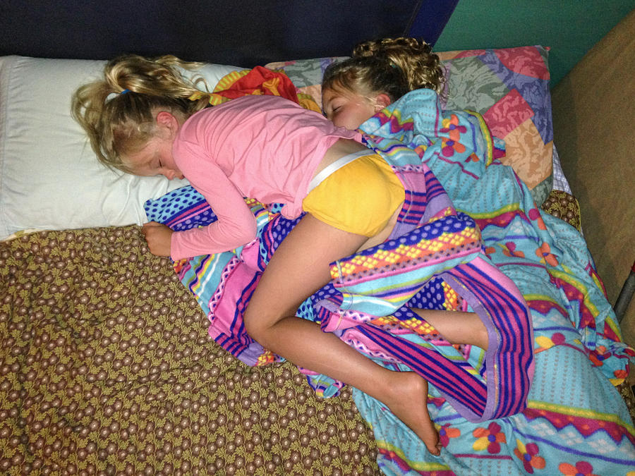 Two siblings intertwined whilst sleeping together Photograph by Jodie Griggs