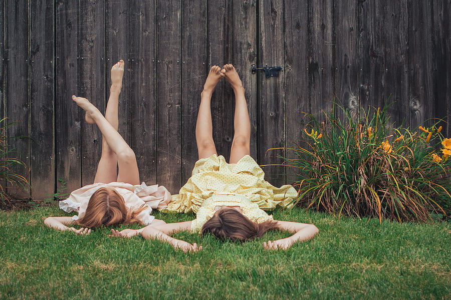 Two Sisters Lying On The Grass Photograph by Itziar Aio