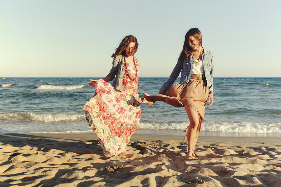 Two stylish women on the beach Photograph by Photo by Rafa Elias