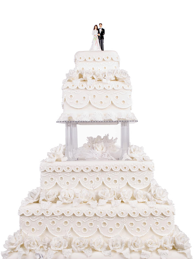 Two tier wedding cake with plastic couple on top Photograph by Leventince