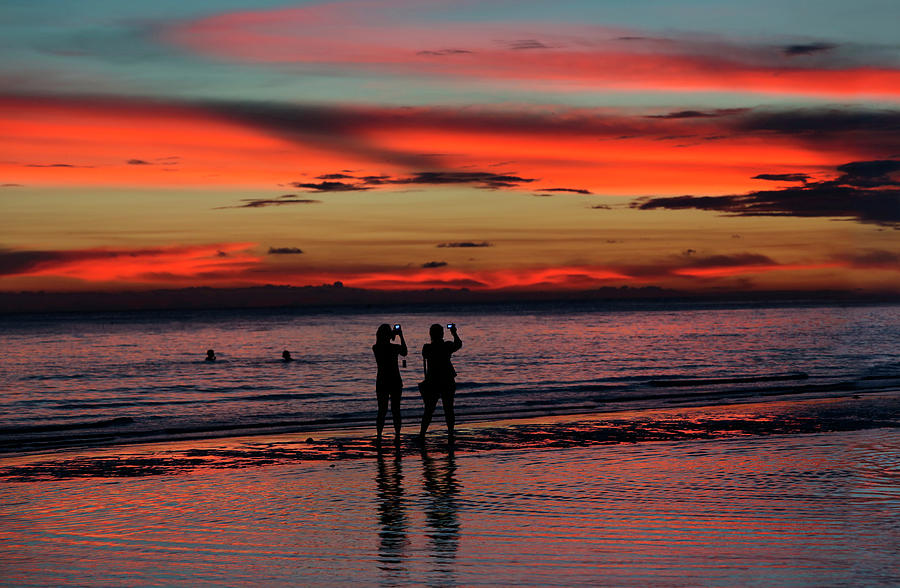 Two Women Photographing Sunset Photograph by Per-Andre Hoffmann - Pixels