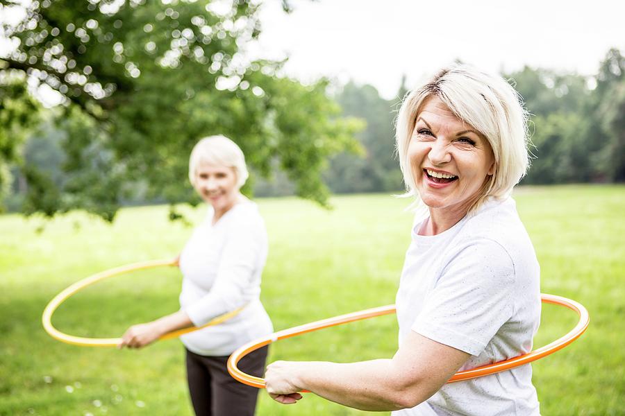 Two Women With Plastic Hoops Photograph by Science Photo Library - Fine ...