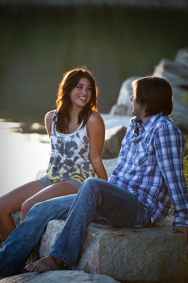 Sunset Photograph - Two Young Adults Smile While Talking by Patrick Orton