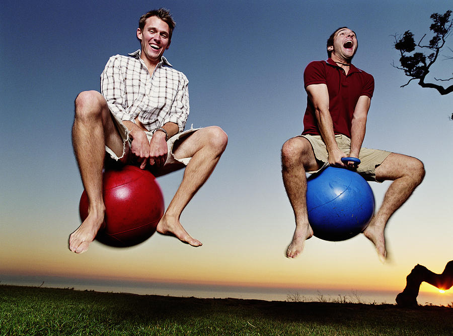 Two young men playing with bounce and hop balls Photograph by Mike Powell