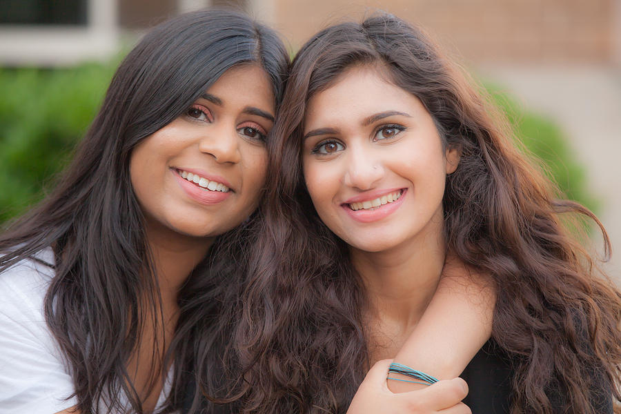 Two young sisters of South Asian ethnicity Photograph by XiFotos