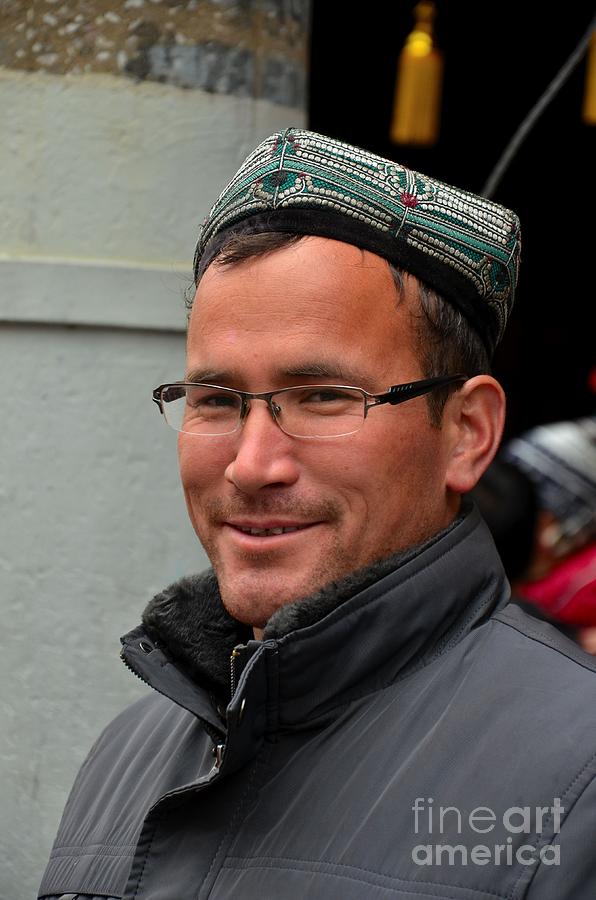 Uighur man in traditional cap smiles Photograph by Imran Ahmed