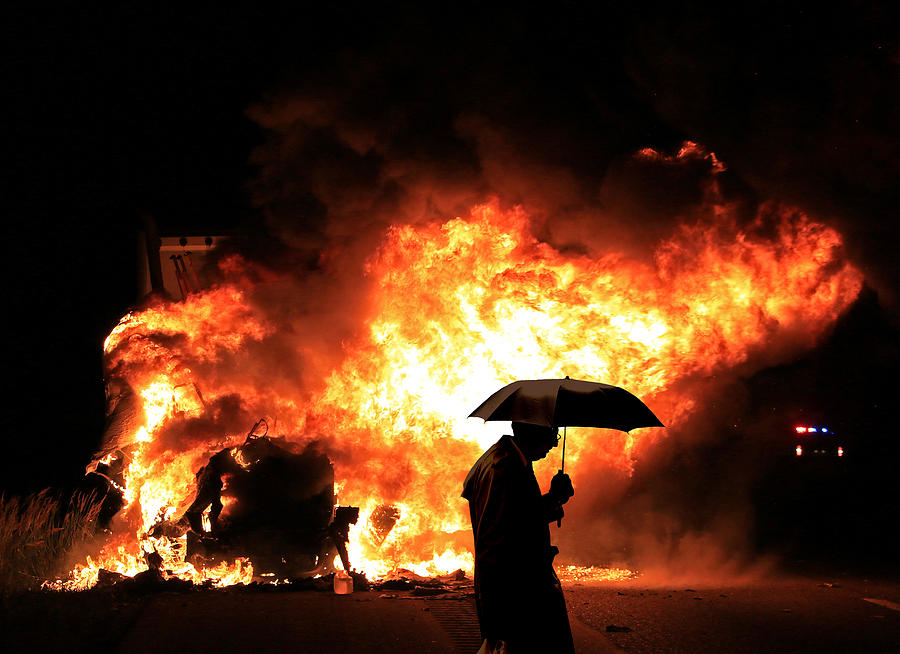 Umbrella Man at Burning Truck Photograph by Christopher McKenzie