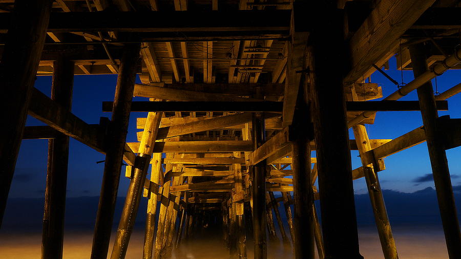 Under the Pier at Night Photograph by Richard Cheski