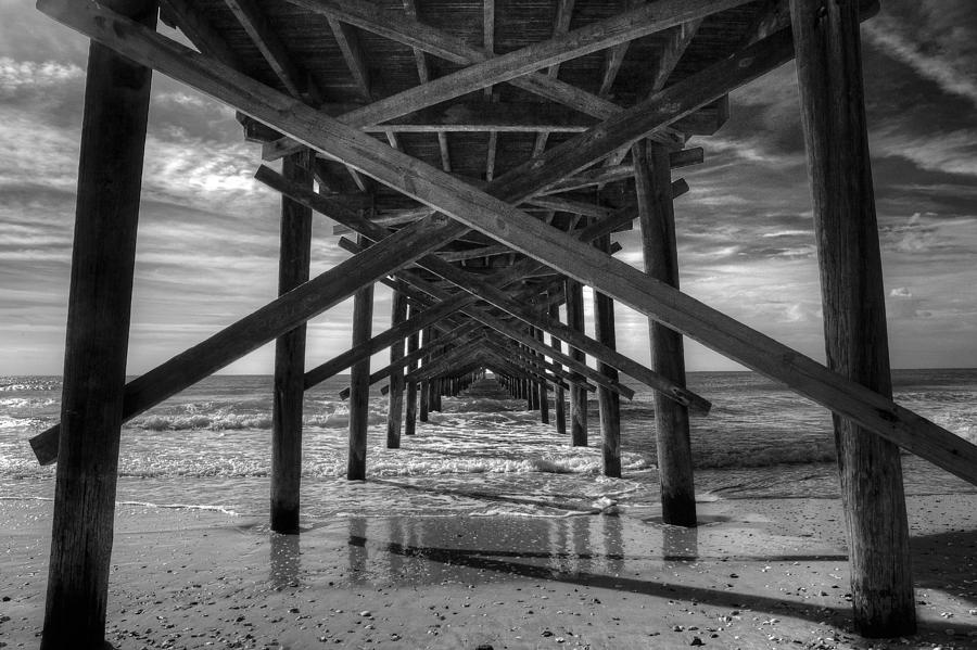 Under the Pier at Sunset Beach Photograph by Steve Gravano