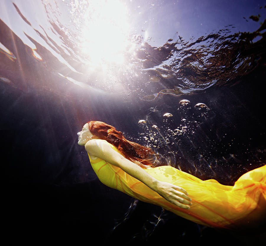 Underwater View Of Woman Swimming To Photograph by Thomas Barwick