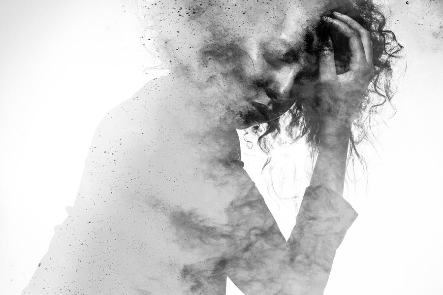 Unhappy womans form double exposed with paint splatter effect Photograph by Wundervisuals