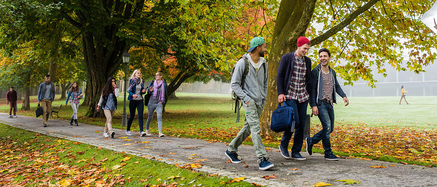 University students walking on footpath Photograph by Simonkr