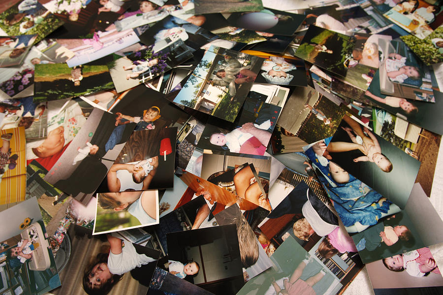 Unorganized pile of photographs of a little girls life Photograph by Lightguard