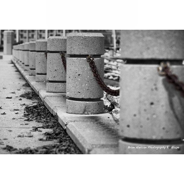 Urban-pillars And Rusty Chain. Racine Photograph by Brian Havican