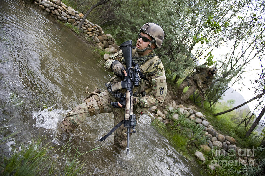 U.s. Army Soldier Walks Through A Creek Photograph by Stocktrek Images