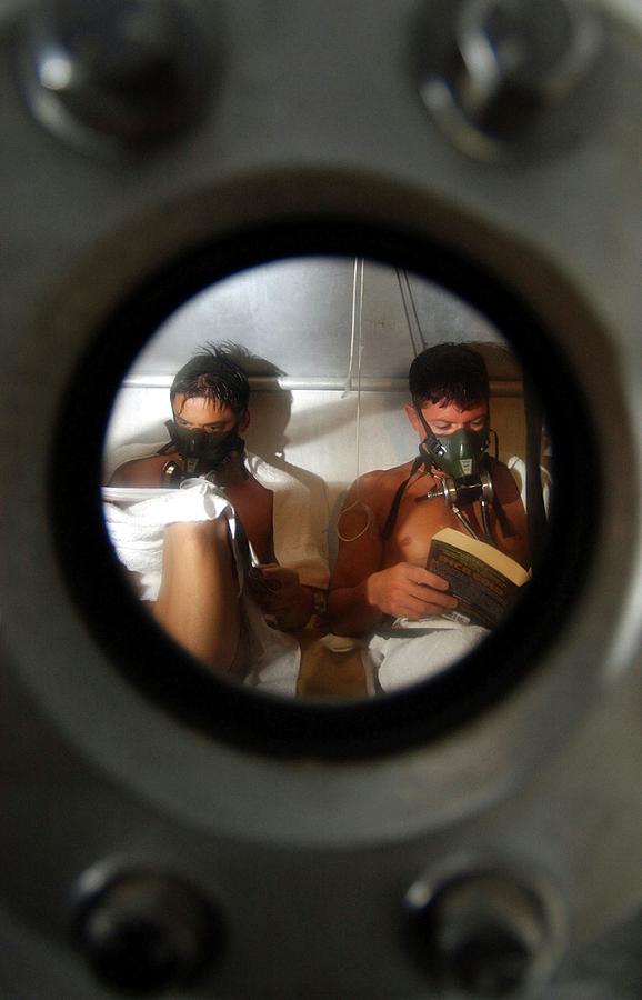 Us Navy Divers In A Decompression Chamber Photograph by Us Navy/chadwick Vann
