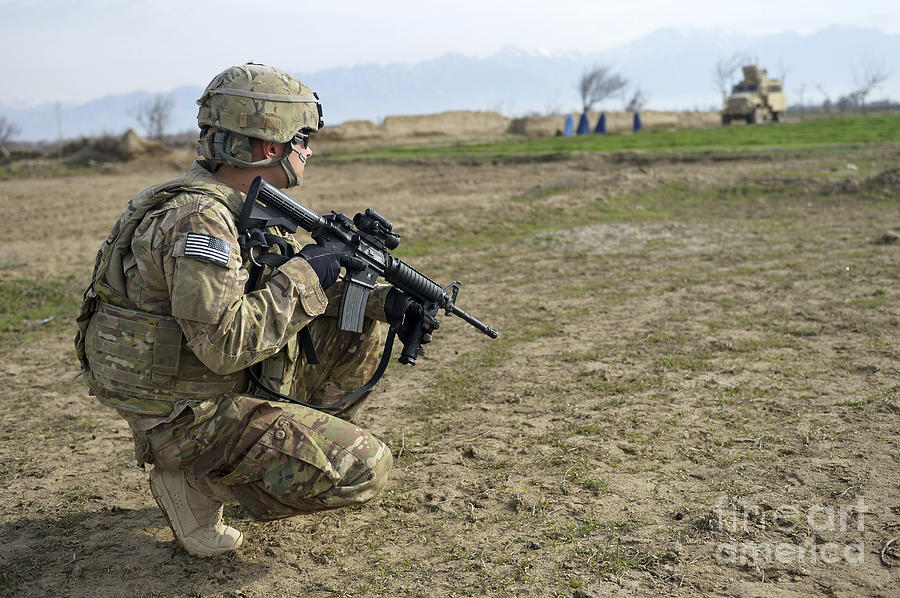 U.s. Soldier Patrols A Village Photograph