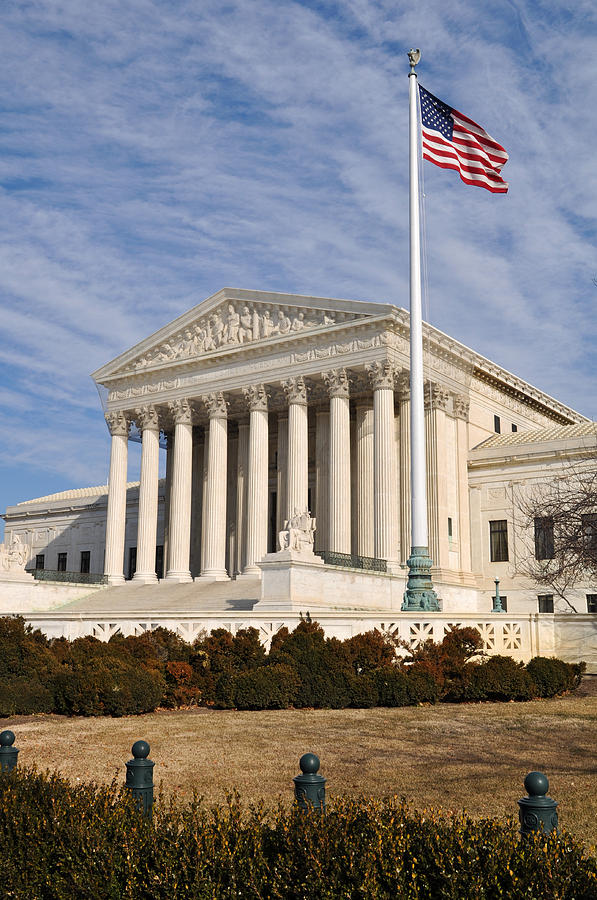 US Supreme Court Building with United States Flag Photograph by Brandon Bourdages
