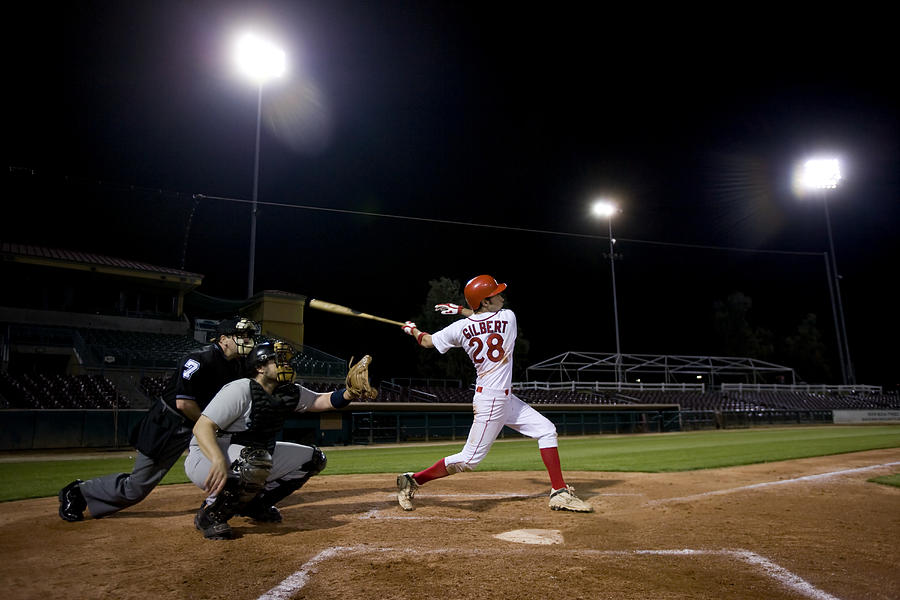 USA, California, San Bernardino, baseball players with batter swinging Photograph by Donald Miralle