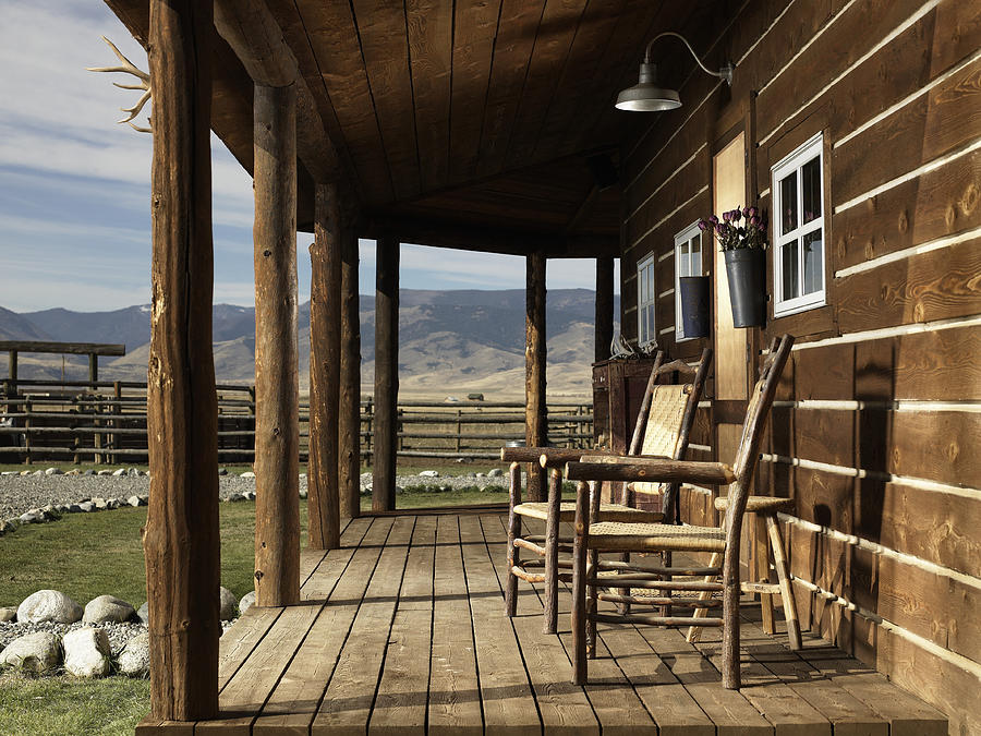 USA, Montana, Bozeman, chairs on porch of cabin Photograph by Ryan McVay