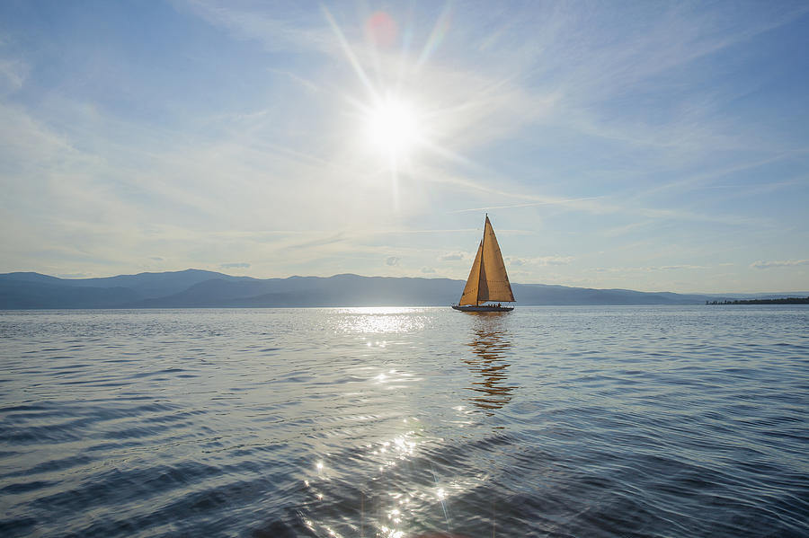 USA, Montana, Flathead Lake, Tranquil scene with sailboat Photograph by Noah Clayton
