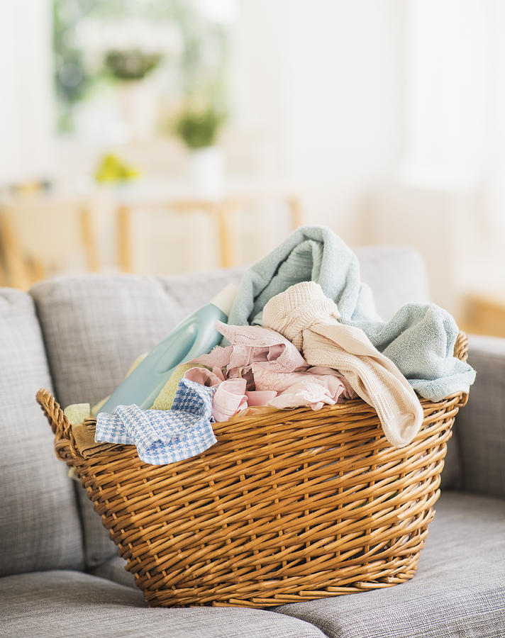 USA, New Jersey, Jersey City, Laundry basket on sofa Photograph by Daniel Grill