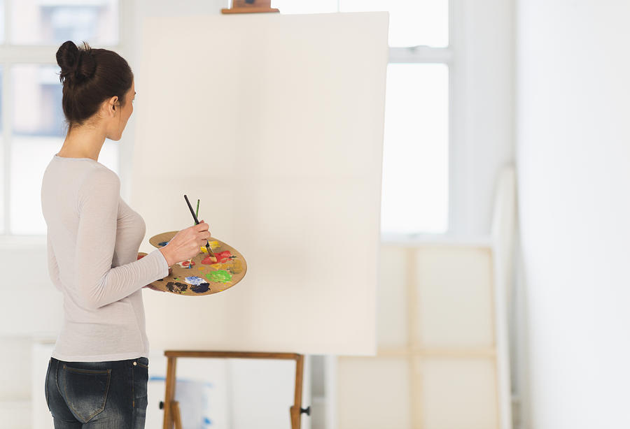 USA, New Jersey, Jersey City, Woman painting at easel Photograph by Tetra Images