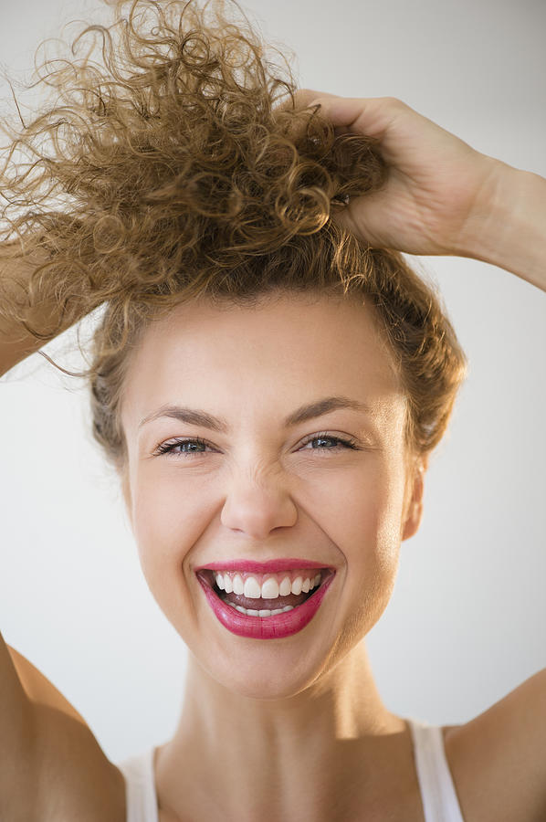 USA, New Jersey, Young woman laughing and holding hair up Photograph by Jamie Grill