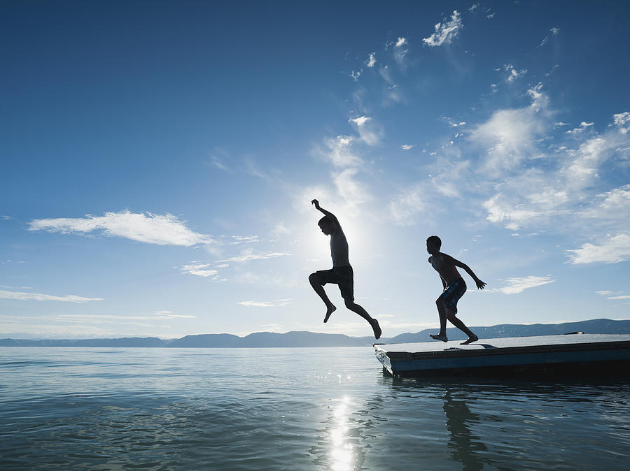 USA, Utah, Garden City, Boys (10-11,12-13) jumping from raft Photograph by Tetra Images - Erik Isakson