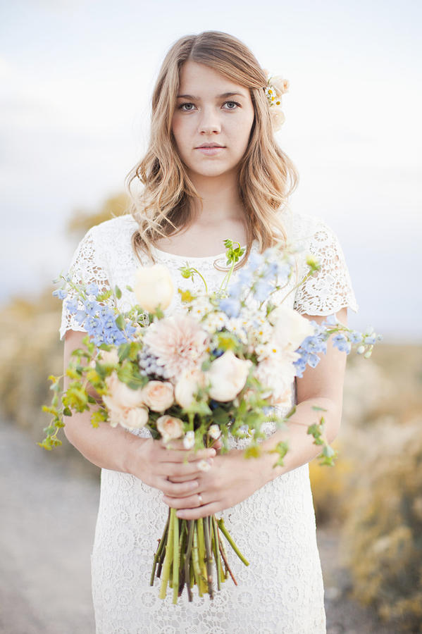USA, Utah, Provo, Waist-up portrait of bride holding bunch of flowers Photograph by Tetra Images - Jessica Peterson
