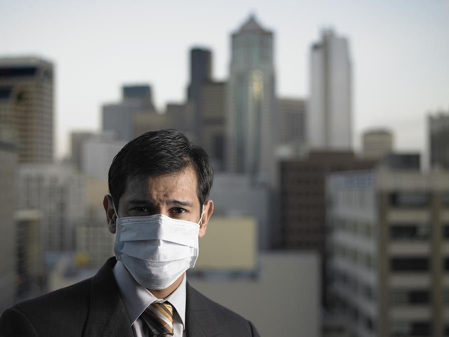 USA, Washington, Seattle, mature businessman wearing surgical mask Photograph by Thomas Barwick