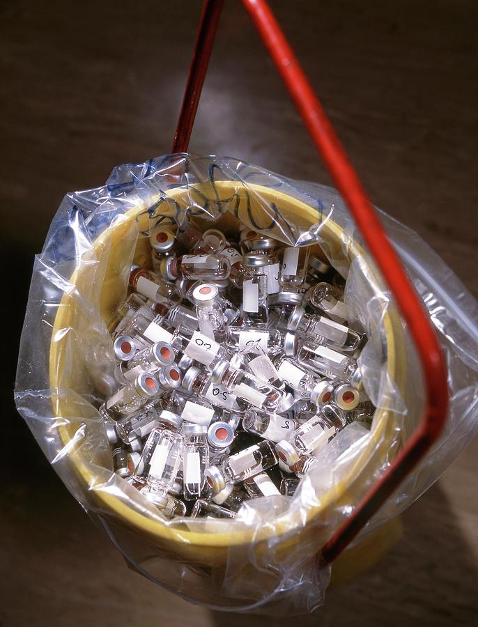Used Vials In A Bucket For Waste Disposal by Tek Image/science Photo