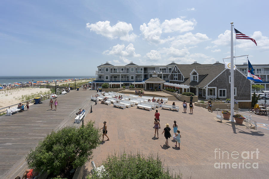 Vacationers visit the boardwalk and bandstand in Bethany Beach Photograph by William Kuta