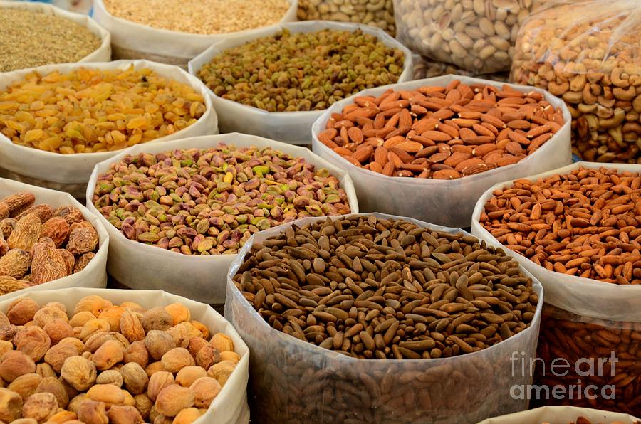 Variety of raw nuts for sale at outdoor street market Karachi Pakistan Photograph by Imran Ahmed