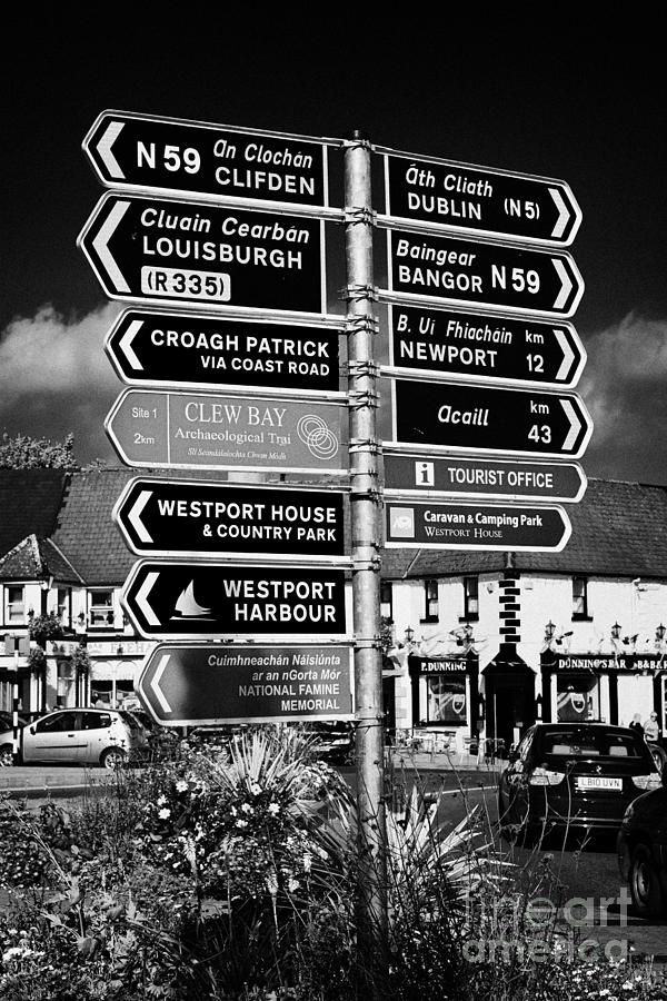 Sign Photograph - Various Road Direction Signs In Westport County Mayo Republic Of Ireland by Joe Fox