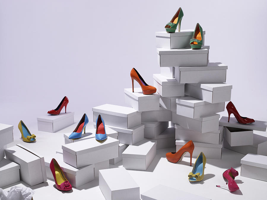 Various shoes piled on shoe boxes Photograph by Michael Blann