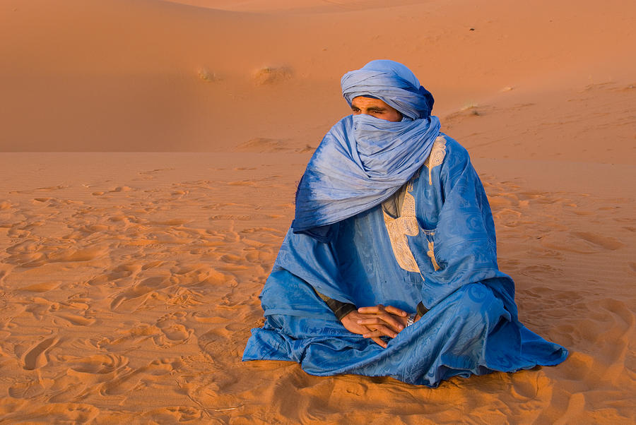 Color Image Photograph - Veiled Tuareg Man Sitting Cross-legged by Panoramic Images